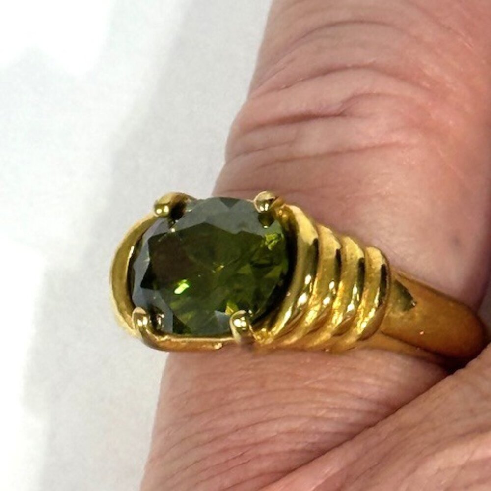 Gold-tone and peridot-colored stone fashion ring.